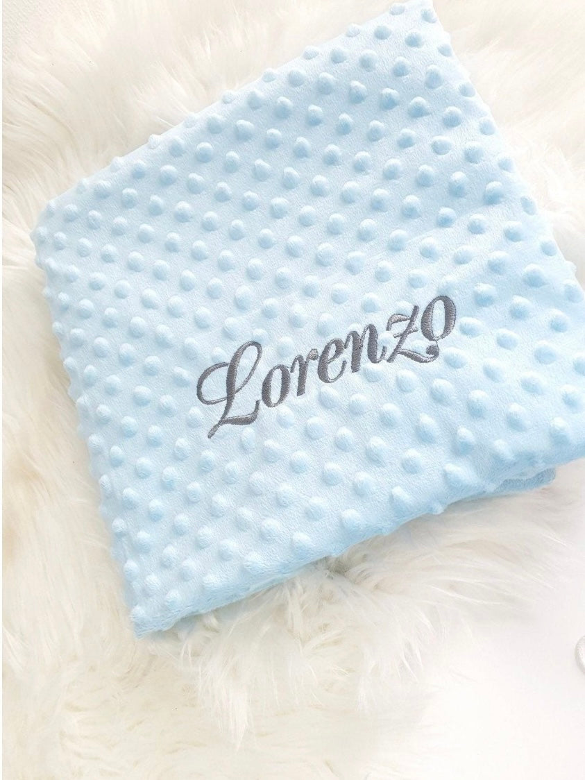 Blue blanket with dark gray embroidery