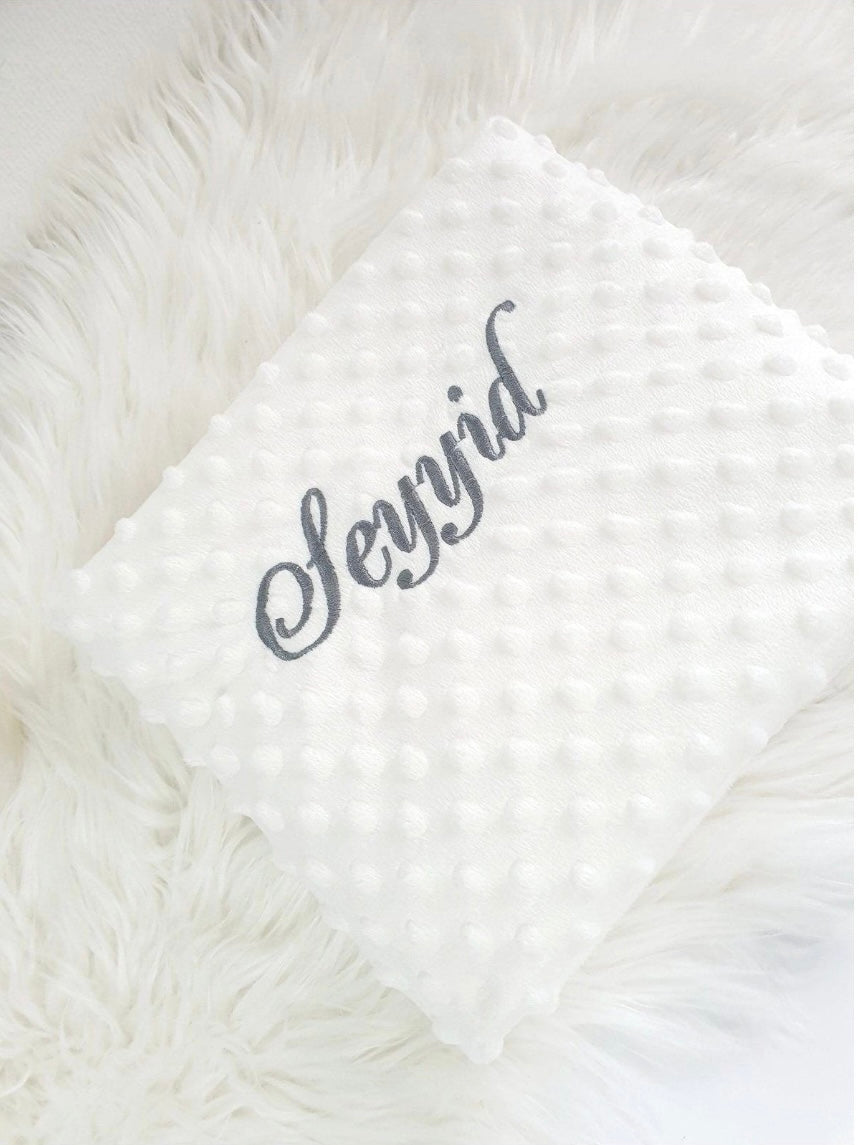 White blanket with gray embroidery