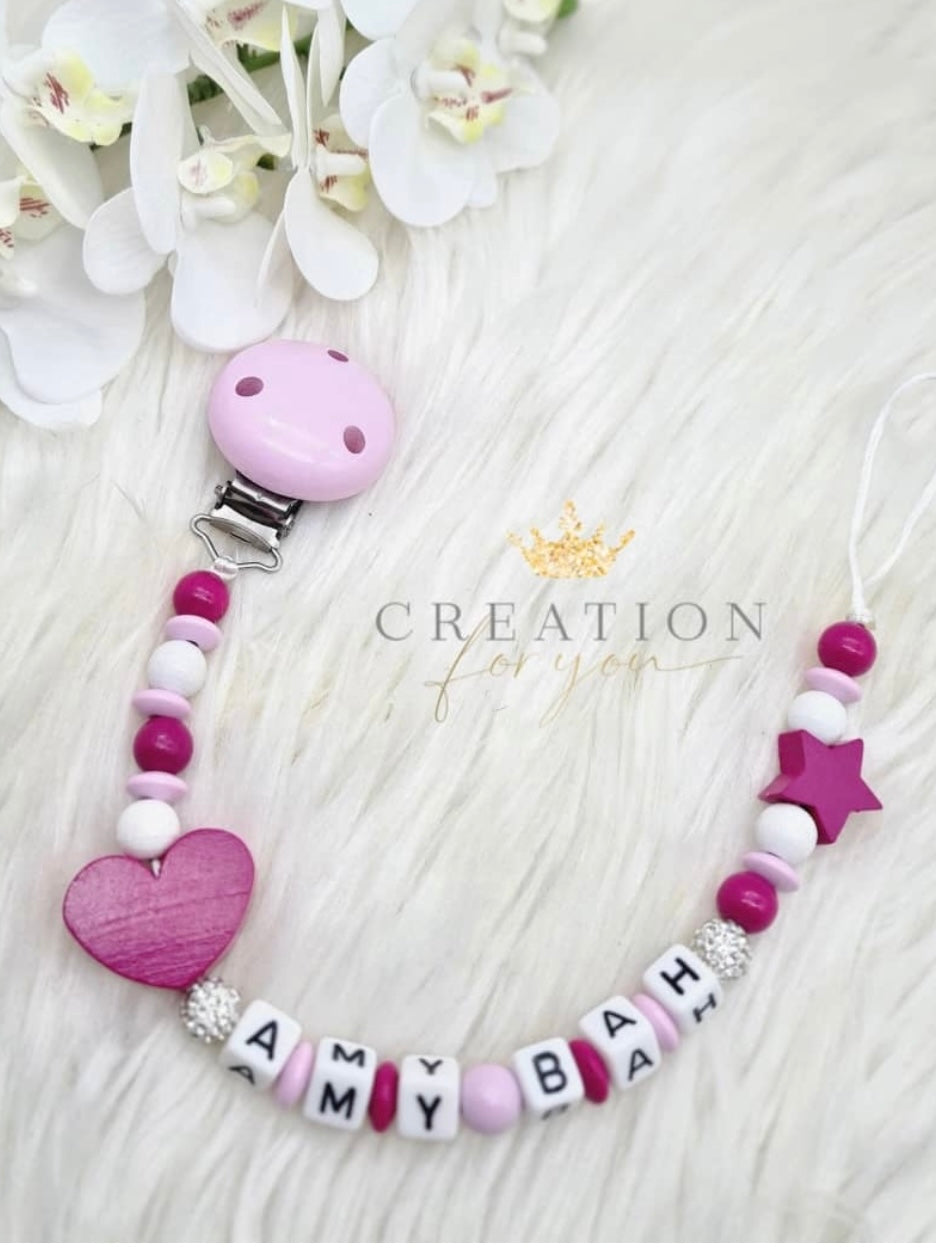 Attache tetine rose