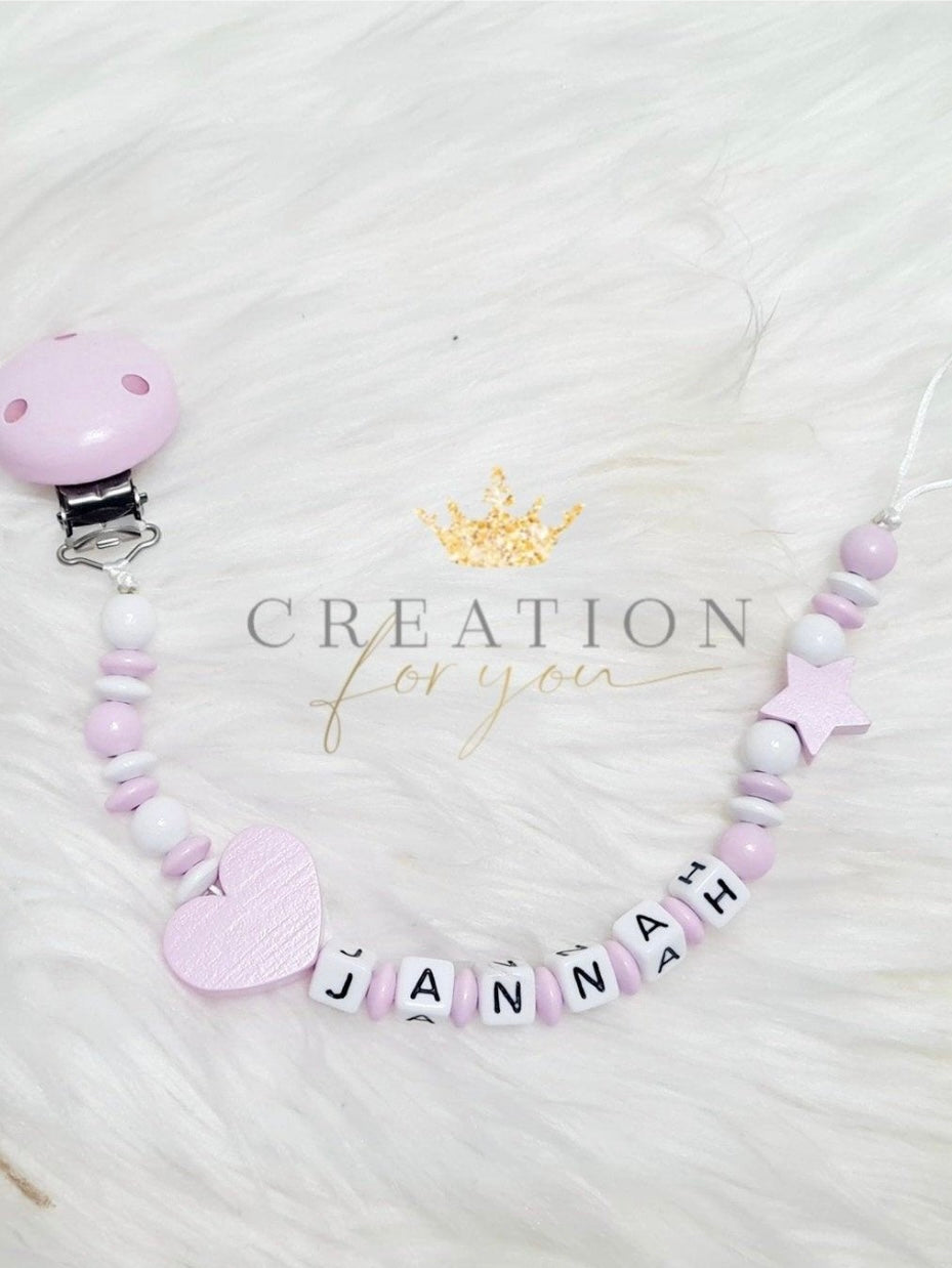 White and pink pacifier clip